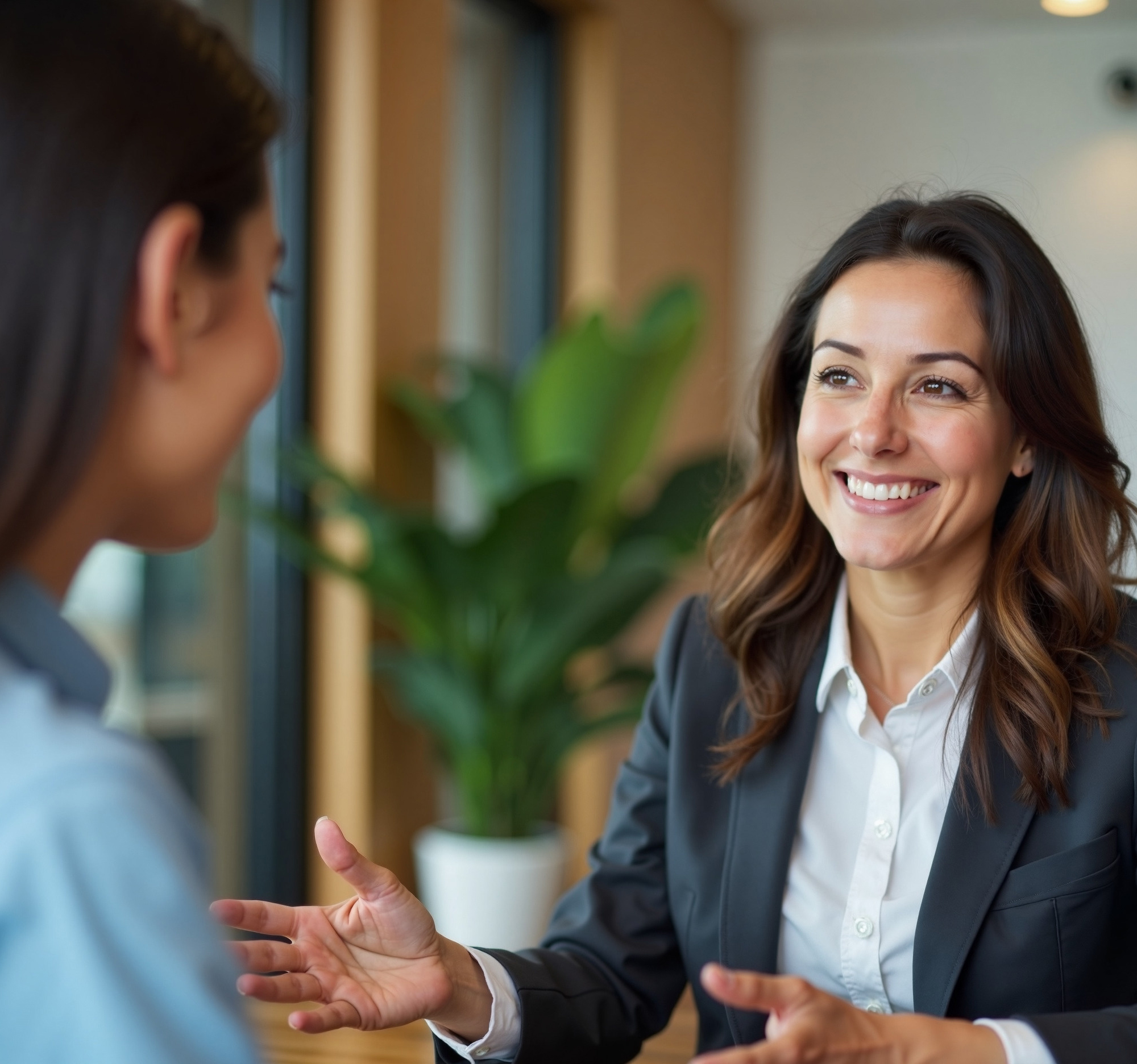 Engaging professional dialogue between two women in a modern office