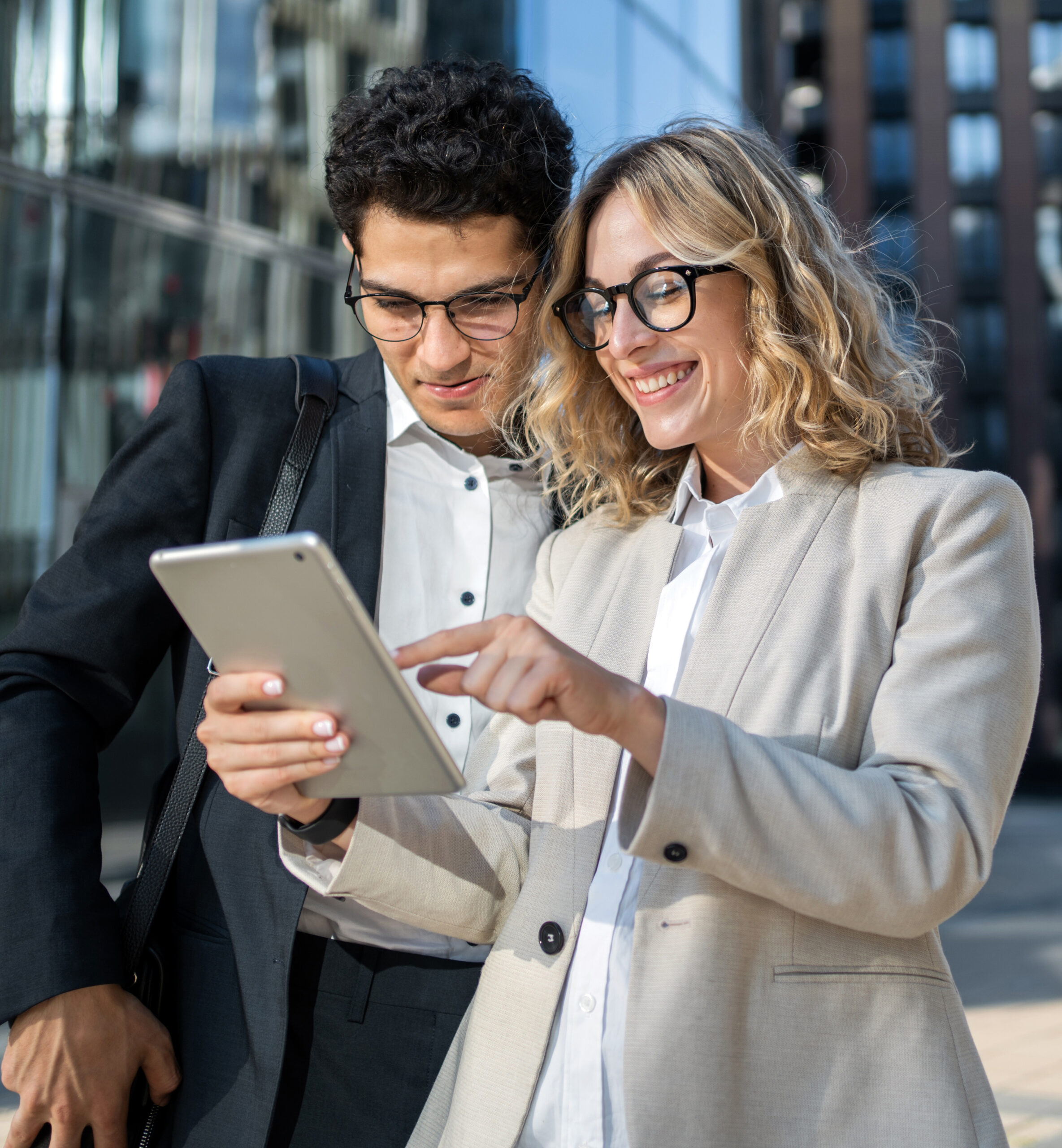 A man and a woman viewing a tablet