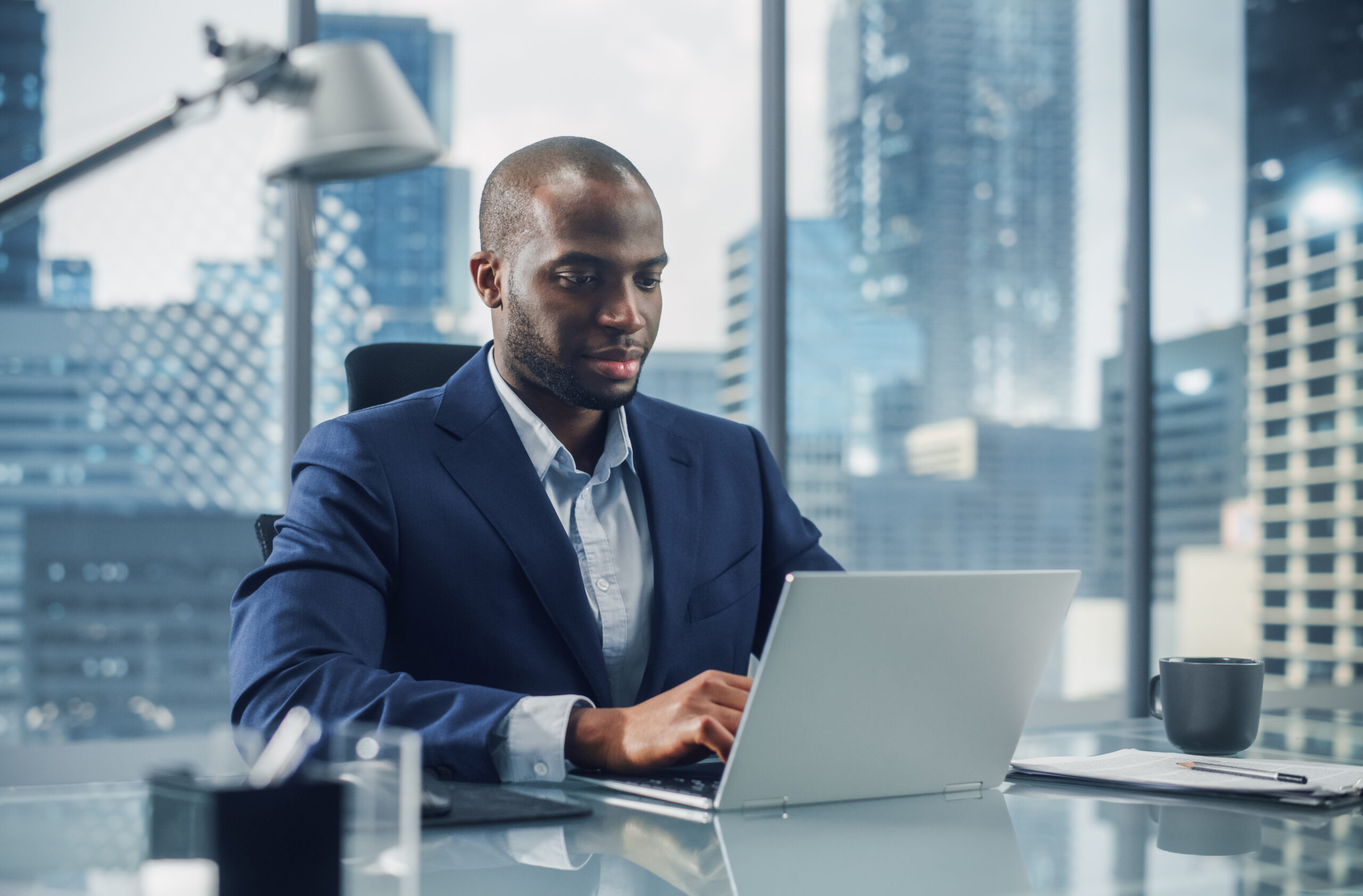 Man in city office typing on a computer