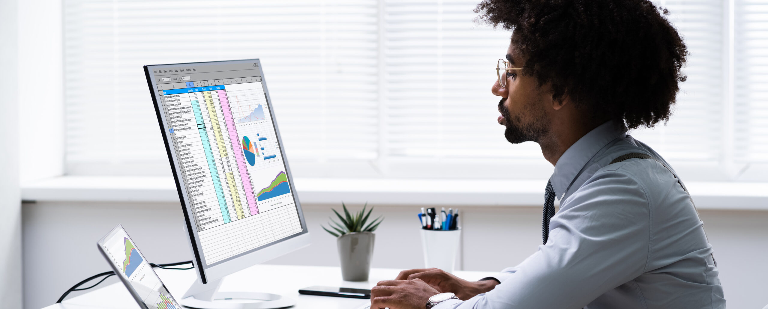 Businessman looking at chart and graphs on a computer