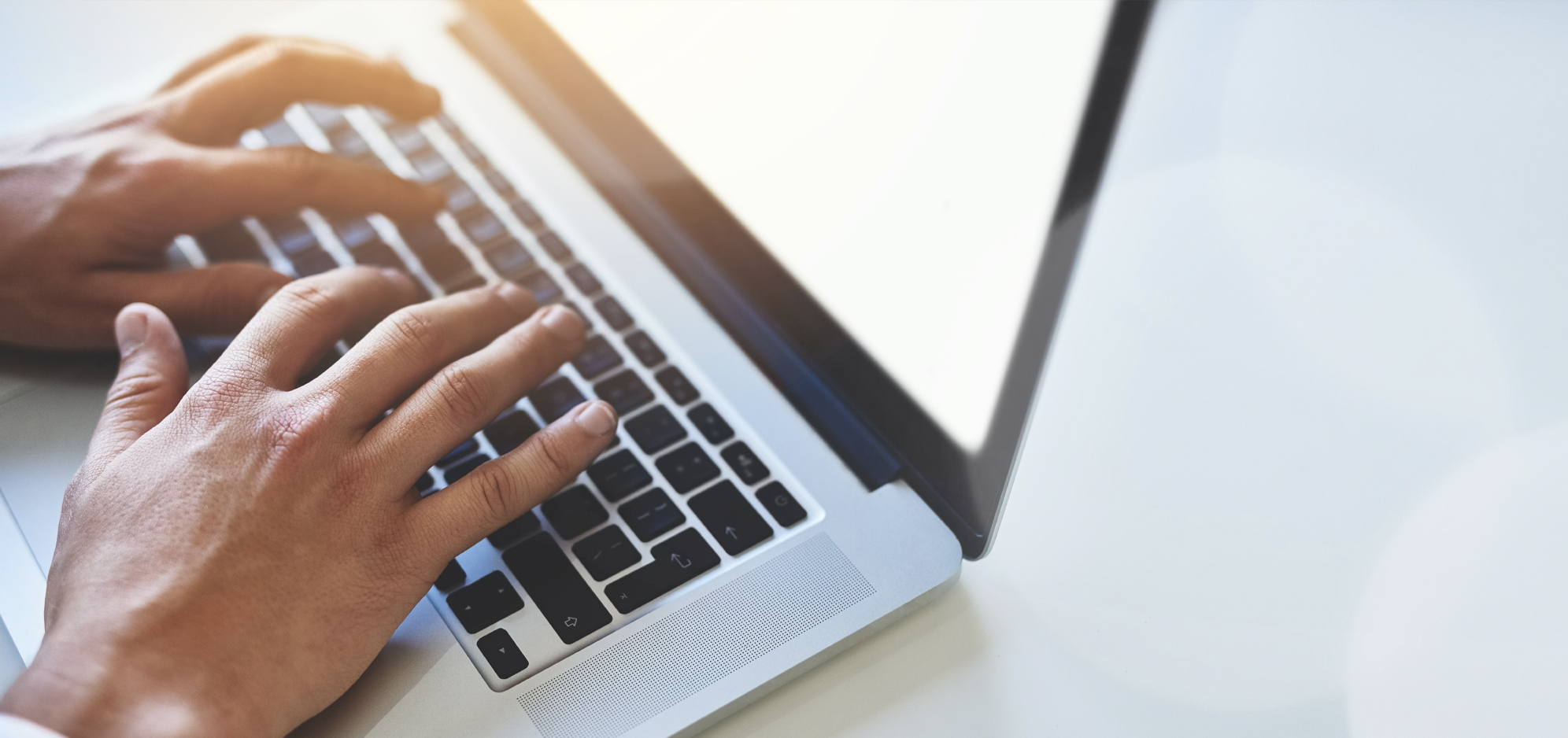 A person typing on a laptop