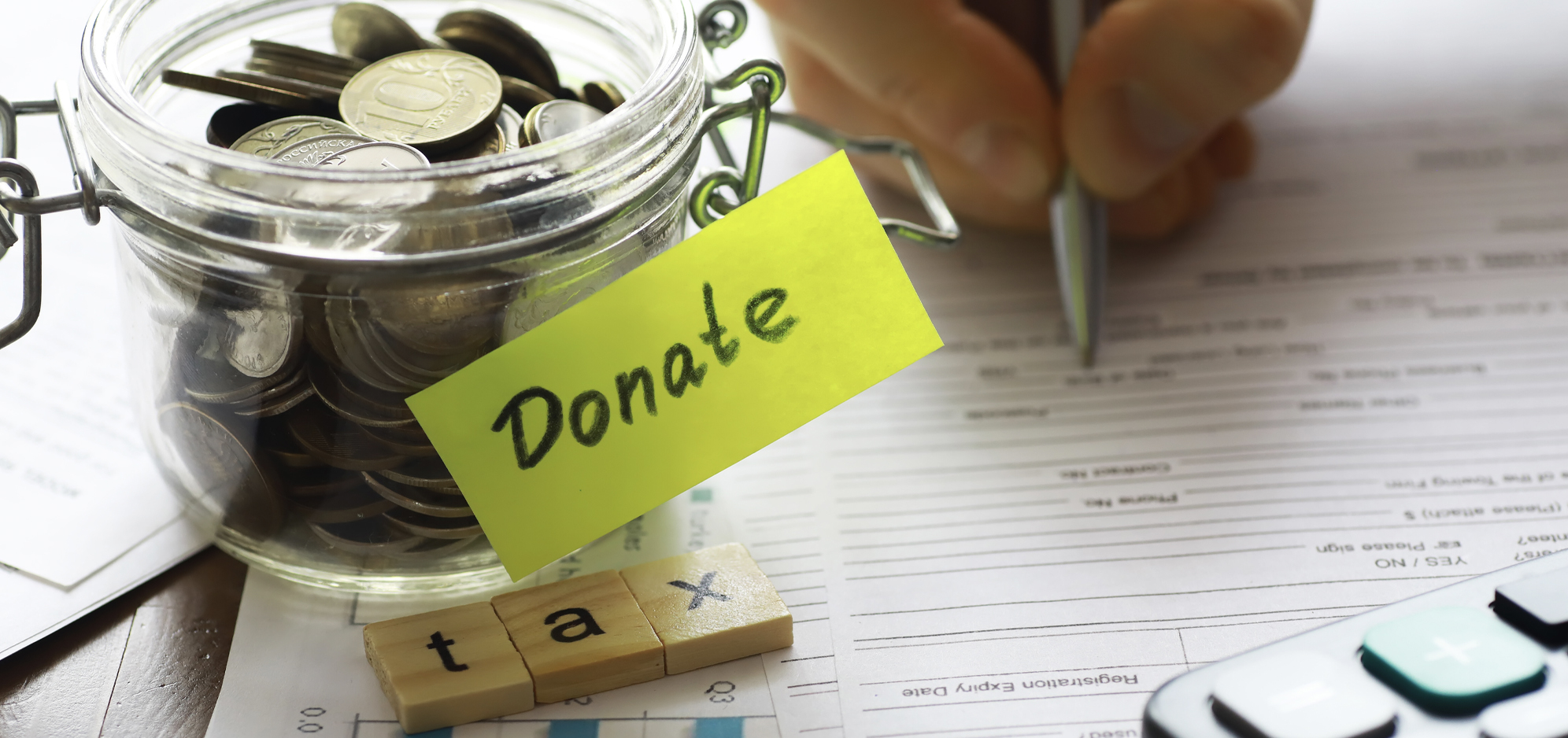Jar of coins with a post-it saying donate