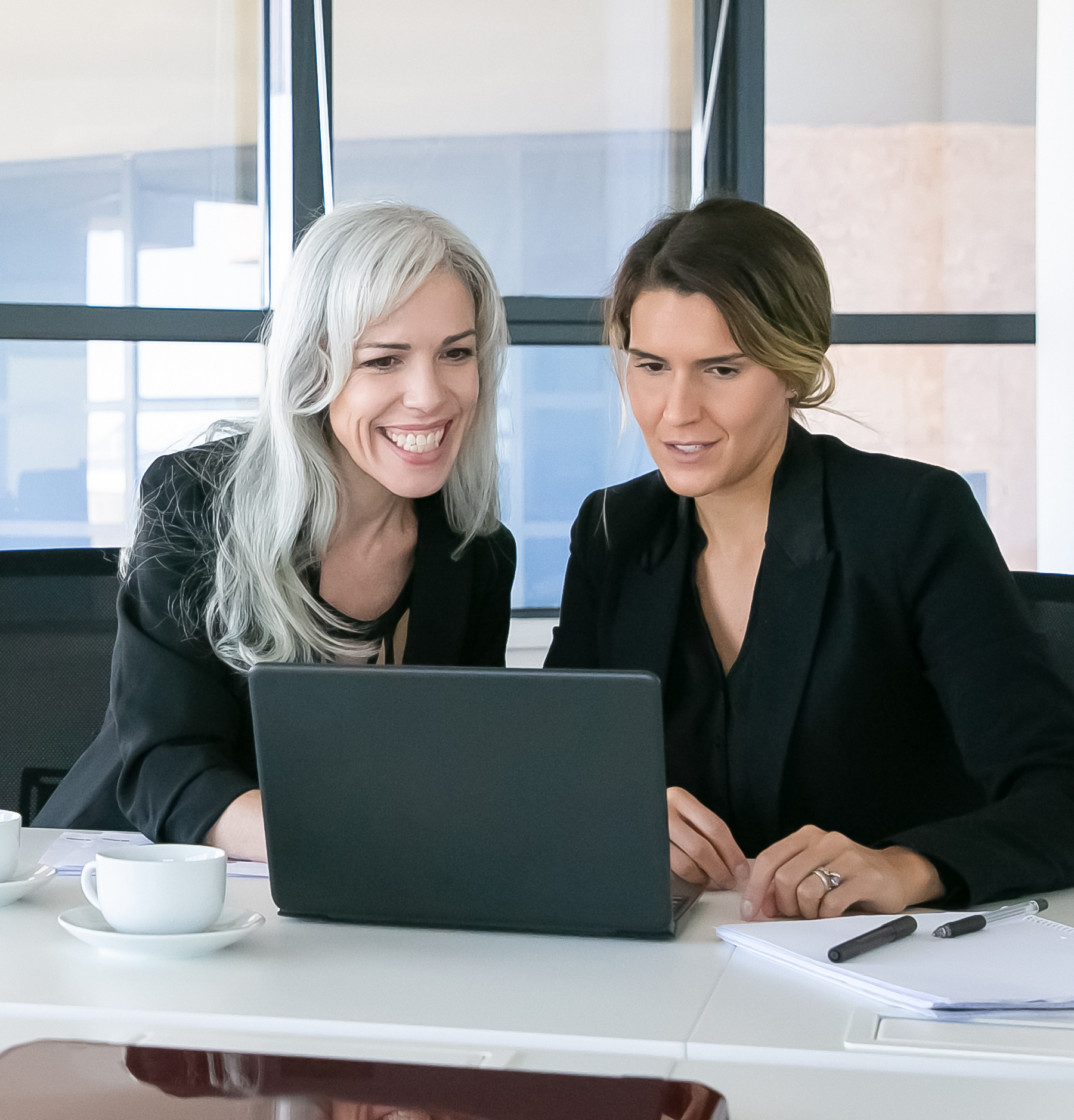 Two women looking at a computer