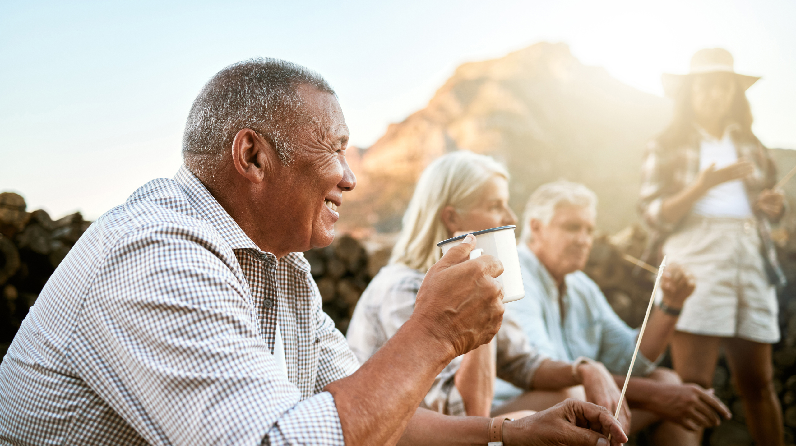 Group of retired people drinking coffee outdoors