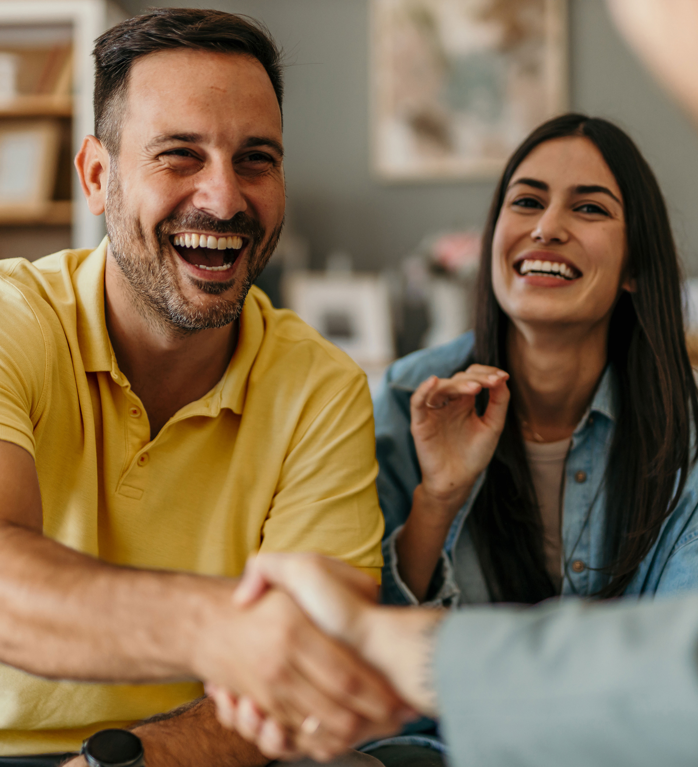 Happy couple closing a financial planning agreement